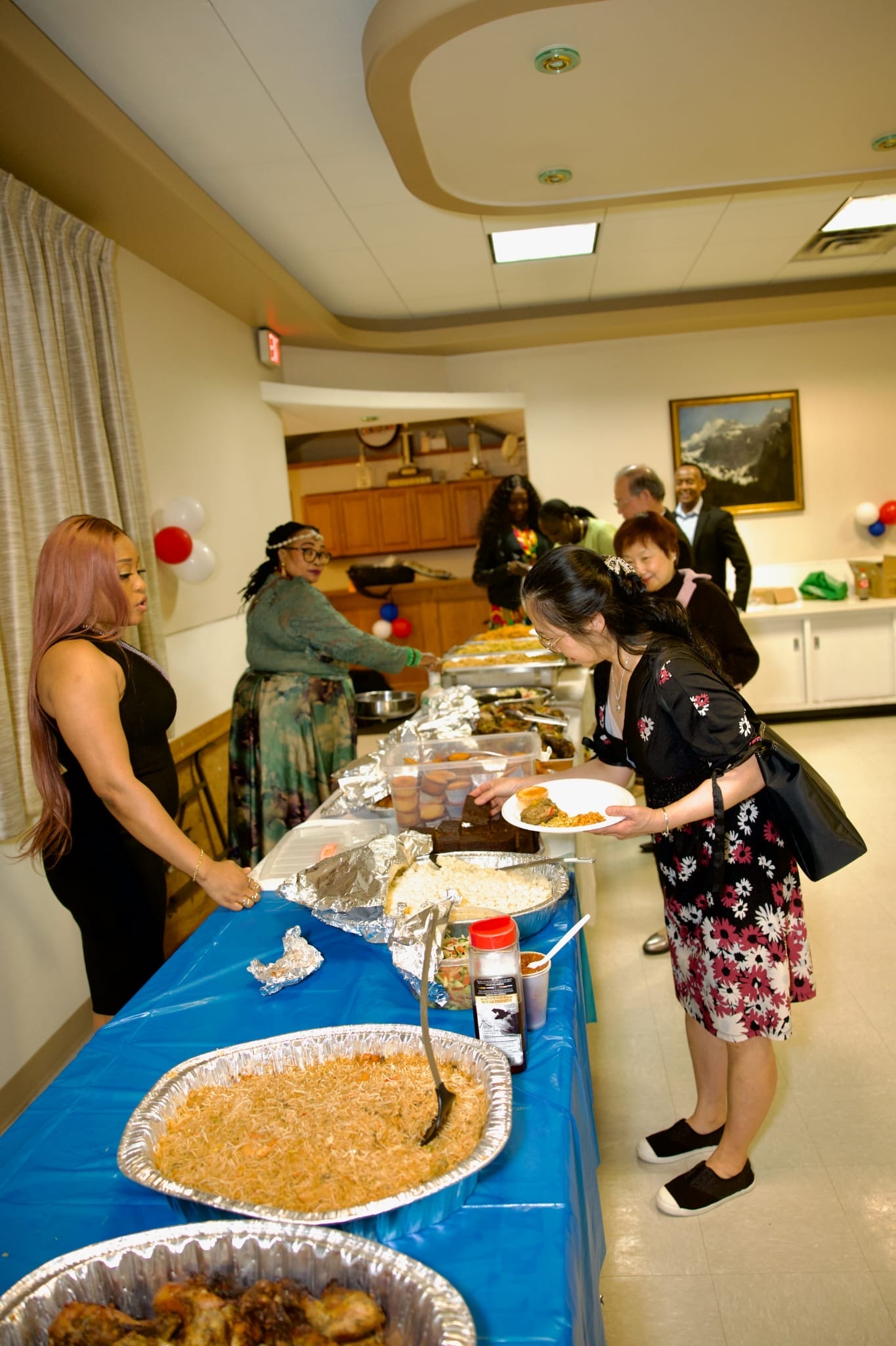 Community members serving food at W.A.C.A.BC event